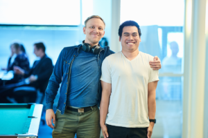 Two Teamit employees standing and smiling